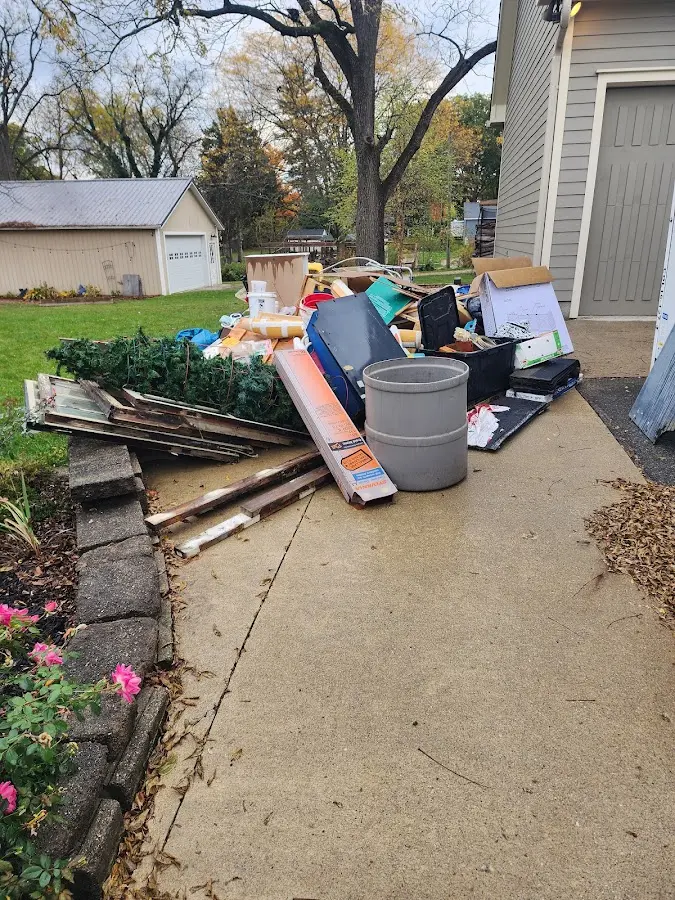 Dumpster being loaded with debris for Estate Cleanout Dumpster Rental in Sewanee